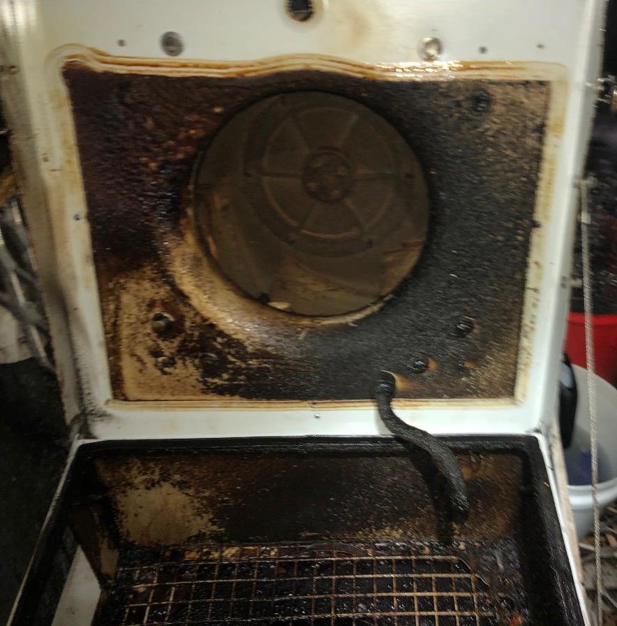 Exhaust fan chamber heavily soiled with grease before cleaning