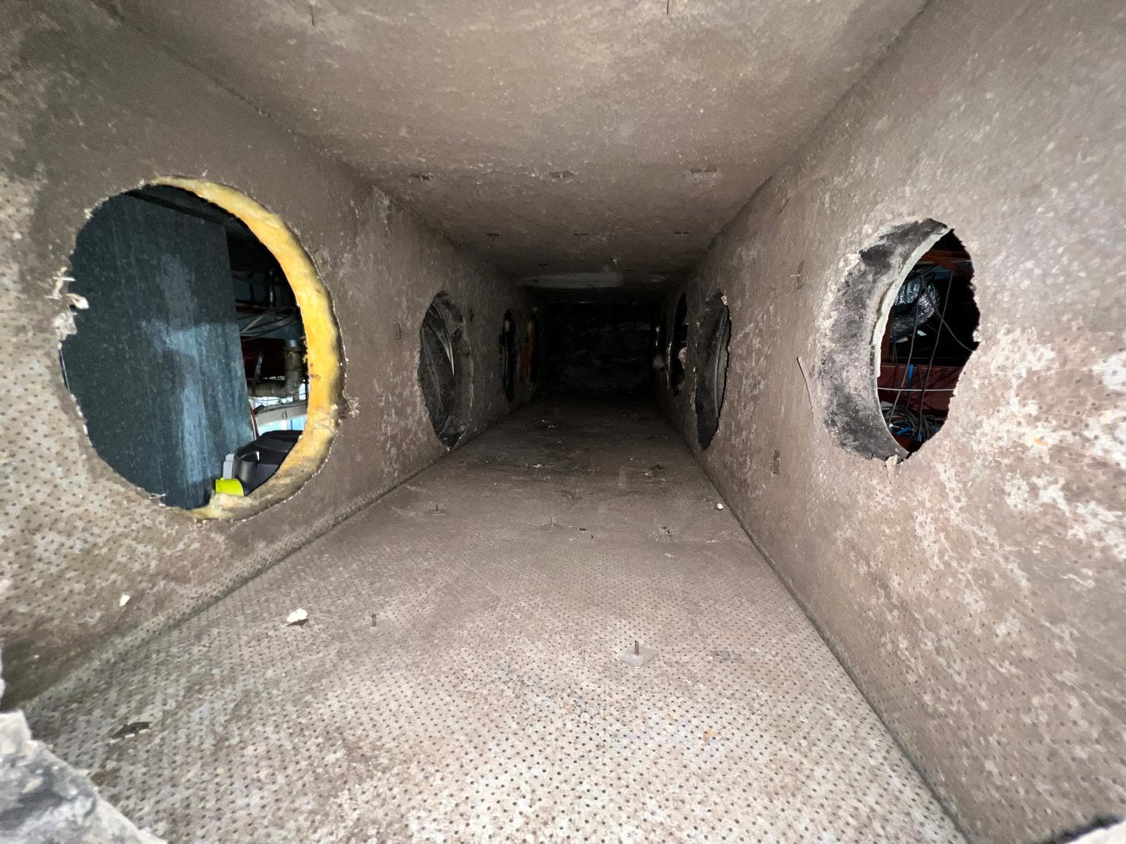Interior of kitchen exhaust ductwork with access panel openings visible along its length