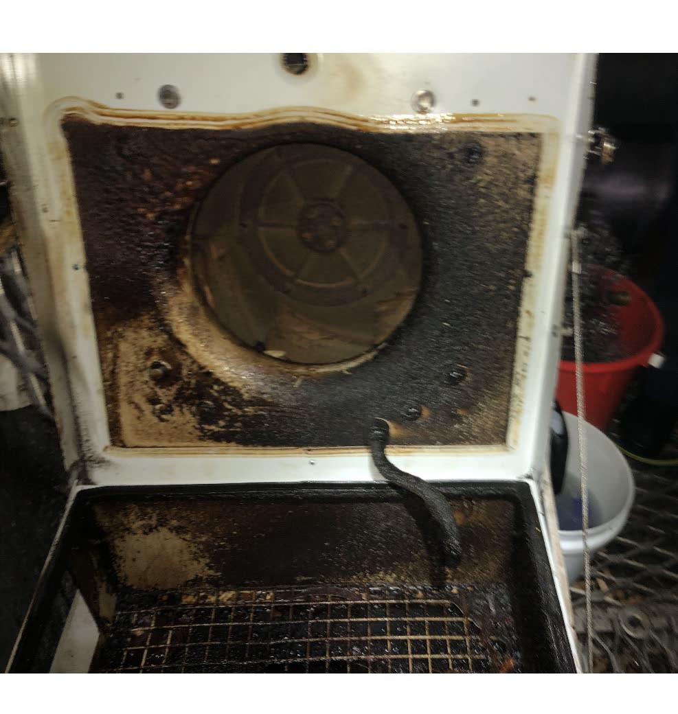 Severely grease-caked exhaust fan housing